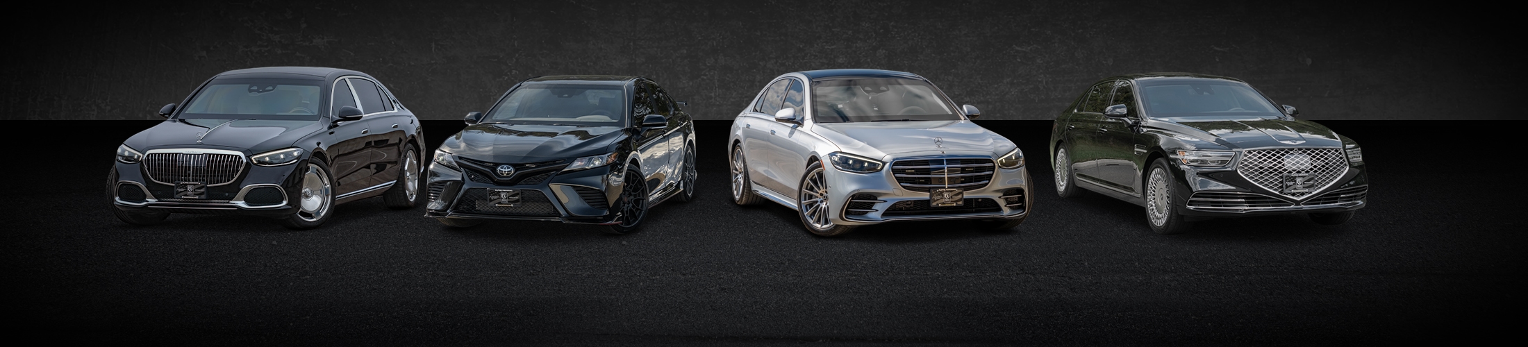 A lineup of four luxury cars displayed against a dark background.