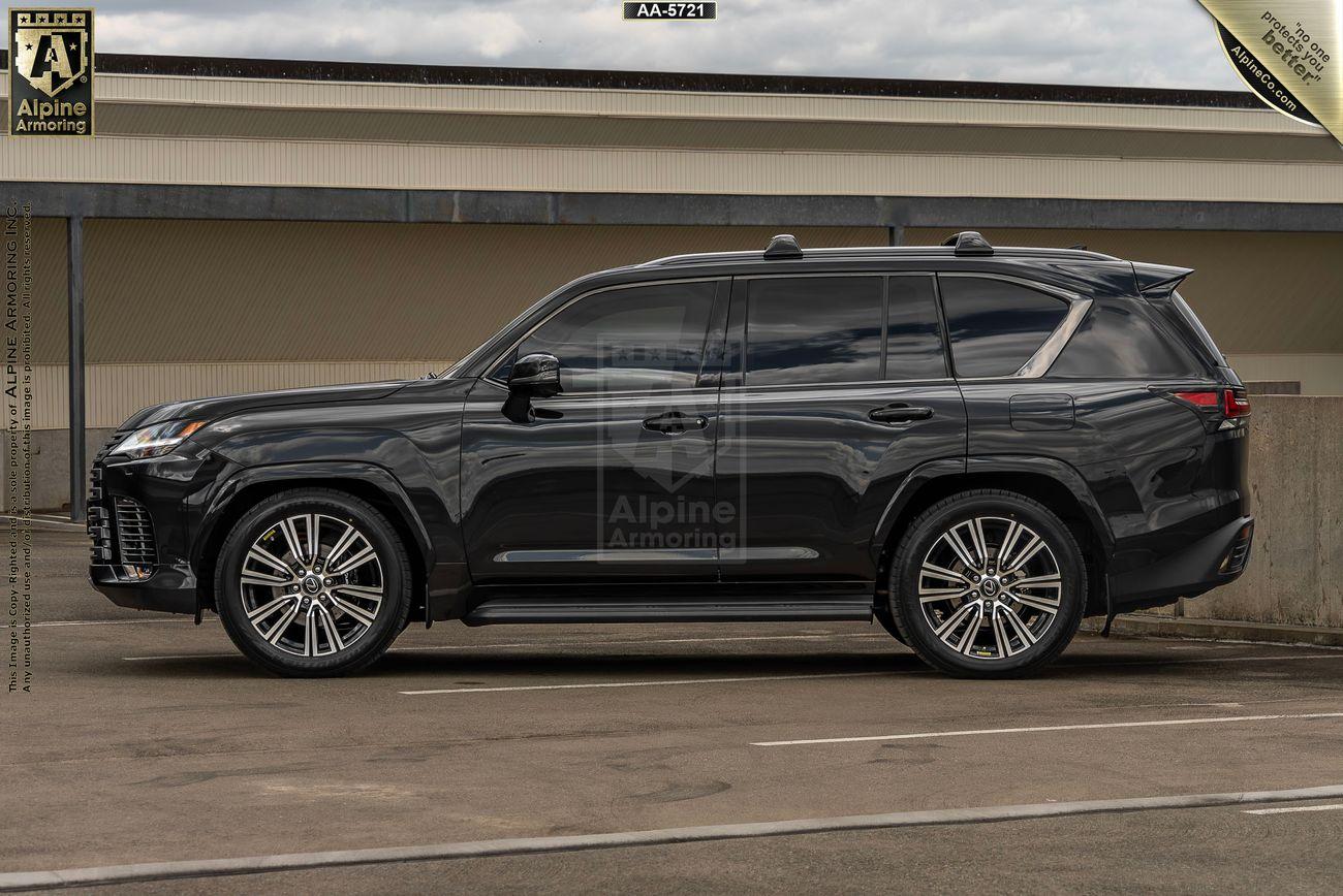 A sleek, black armored Lexus LX 600 Luxury SUV from Alpine Armoring, parked in an outdoor setting, showcasing its robust and sophisticated design.