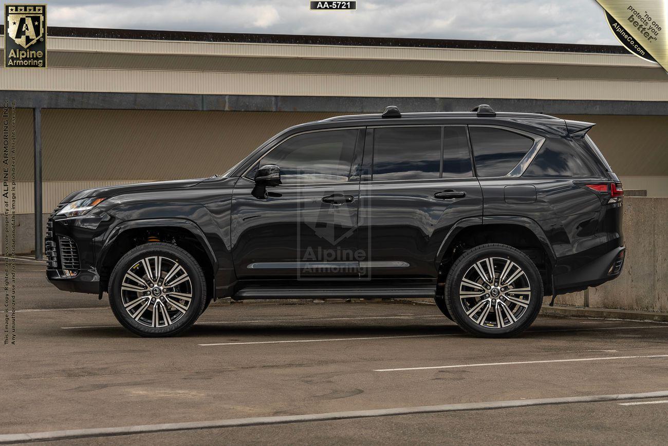 A sleek, black armored Lexus LX 600 Luxury SUV from Alpine Armoring, parked in an outdoor setting, showcasing its robust and sophisticated design.