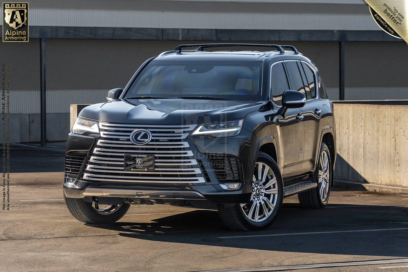 Front view of a black armored Lexus LX600 Ultra Luxury, parked on a rooftop with a concrete background. The vehicle has alloy wheels and a spacious interior.