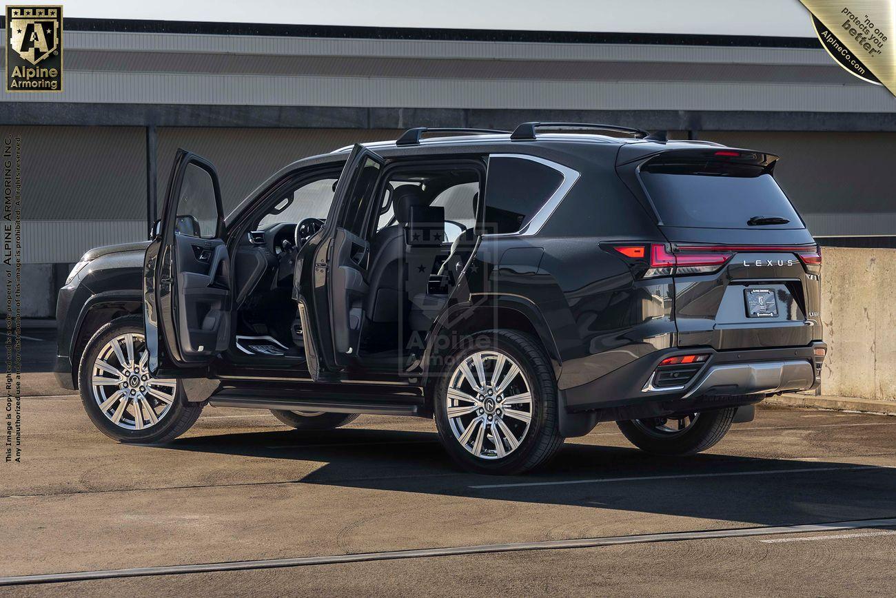 A black armored Lexus LX600 Ultra Luxury with all four doors open is parked on a rooftop with a concrete background. The vehicle has alloy wheels and a spacious interior.