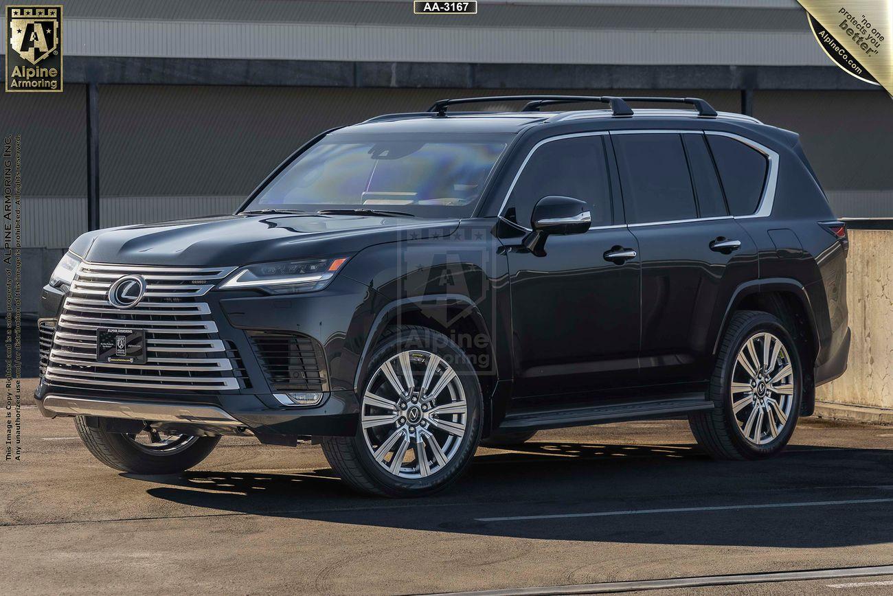 A black Lexus LX 600 Ultra Luxury SUV is parked in an outdoor lot with a building in the background. The vehicle has a modern design with large alloy wheels and tinted windows.