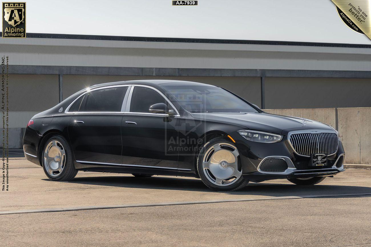 An armored Meredes Maybach viewed from the front right side in a parking area.