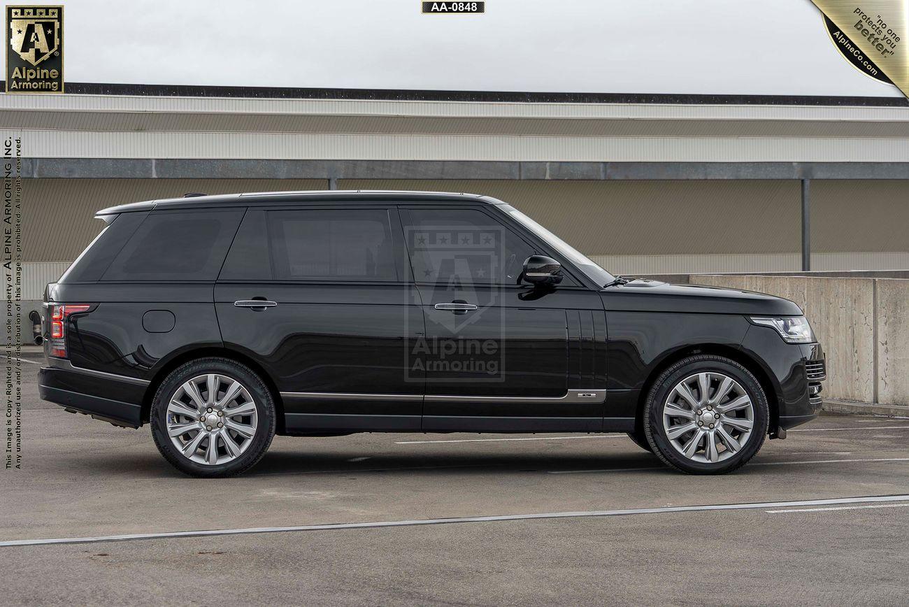 A passenger side view of a black Range Rover Autobiography SUV parked in an outdoor setting, with the logo "Alpine Amazing" visible on the vehicle's window.