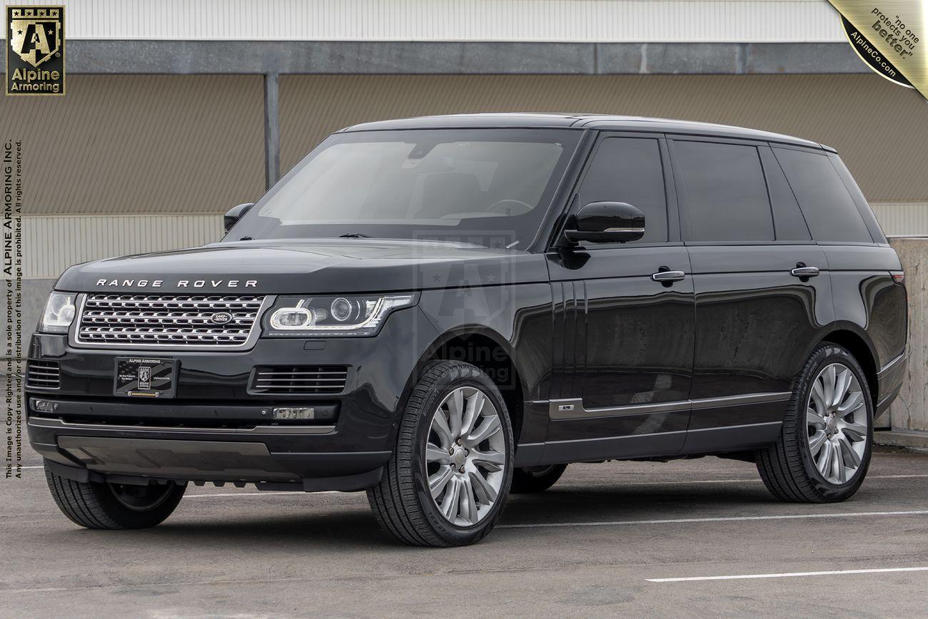 A black Range Rover Autobiography SUV is parked in front of a building. The vehicle has tinted windows and is displayed from the front-left angle. The car features Alpine Armoring branding on the front grill.