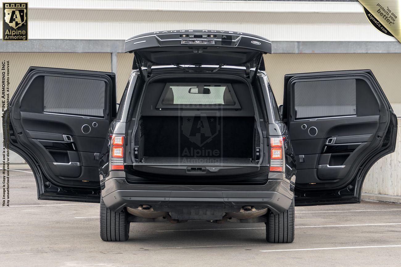 A black Range Rover Autobiogrpahy is parked with its rear and side doors open, showcasing the spacious interior.