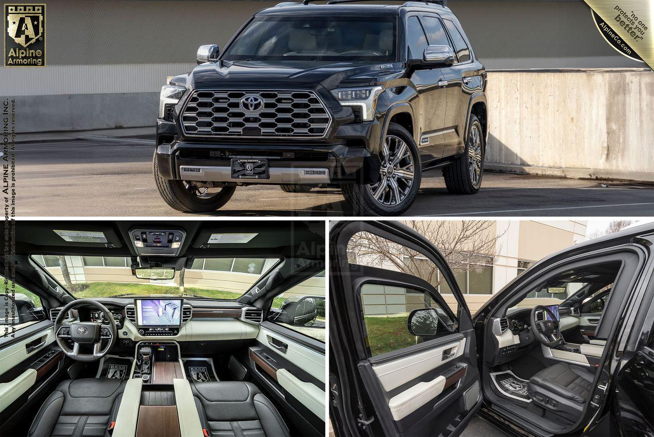 A black armored Toyota Sequoia Capstone from Alpine Armoring, parked with the front doors open, showcasing a luxurious interior and advanced dashboard.