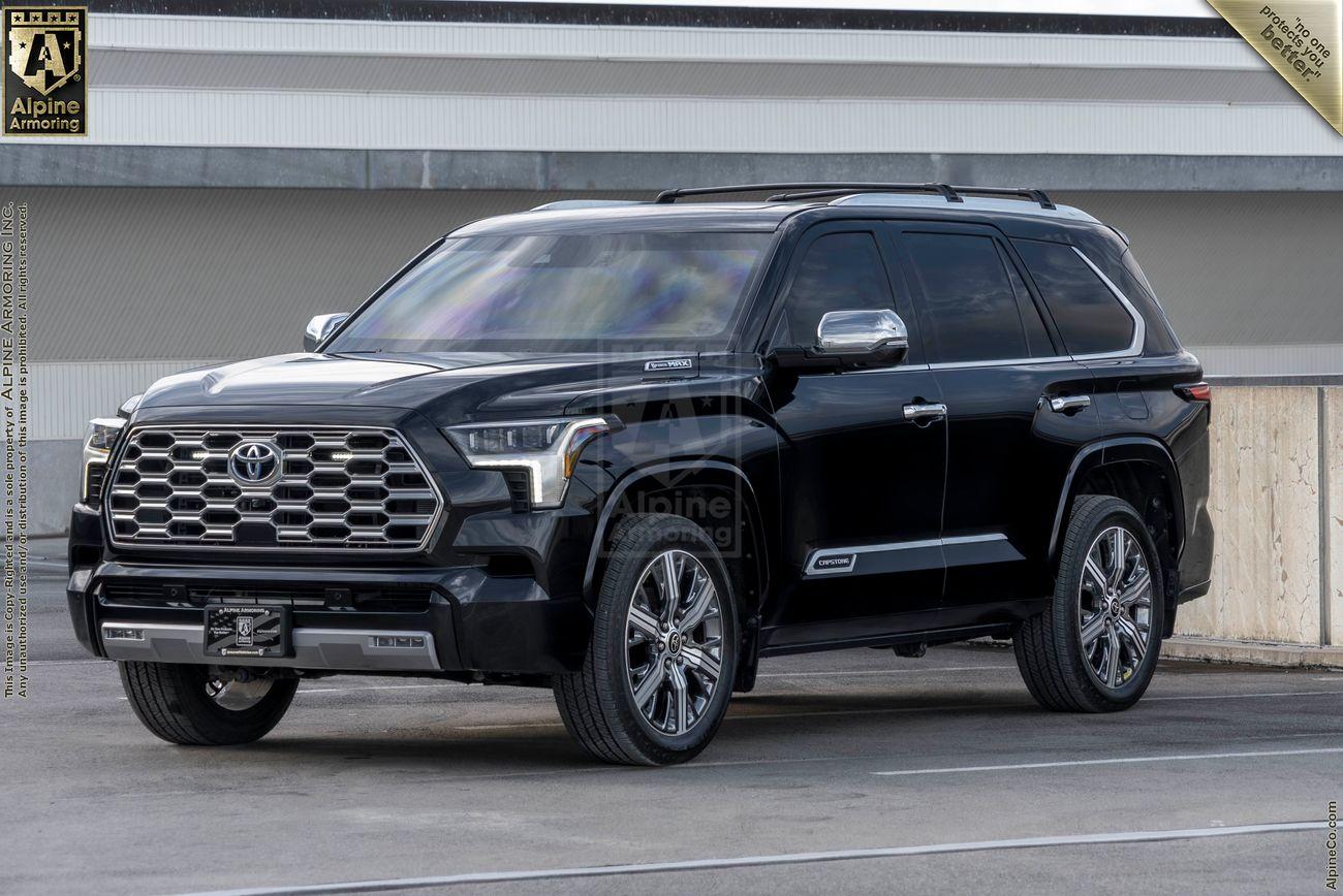 A black armored Toyota Sequoia Capstone from Alpine Armoring, parked outdoors, highlighting its sturdy build and high-end features.