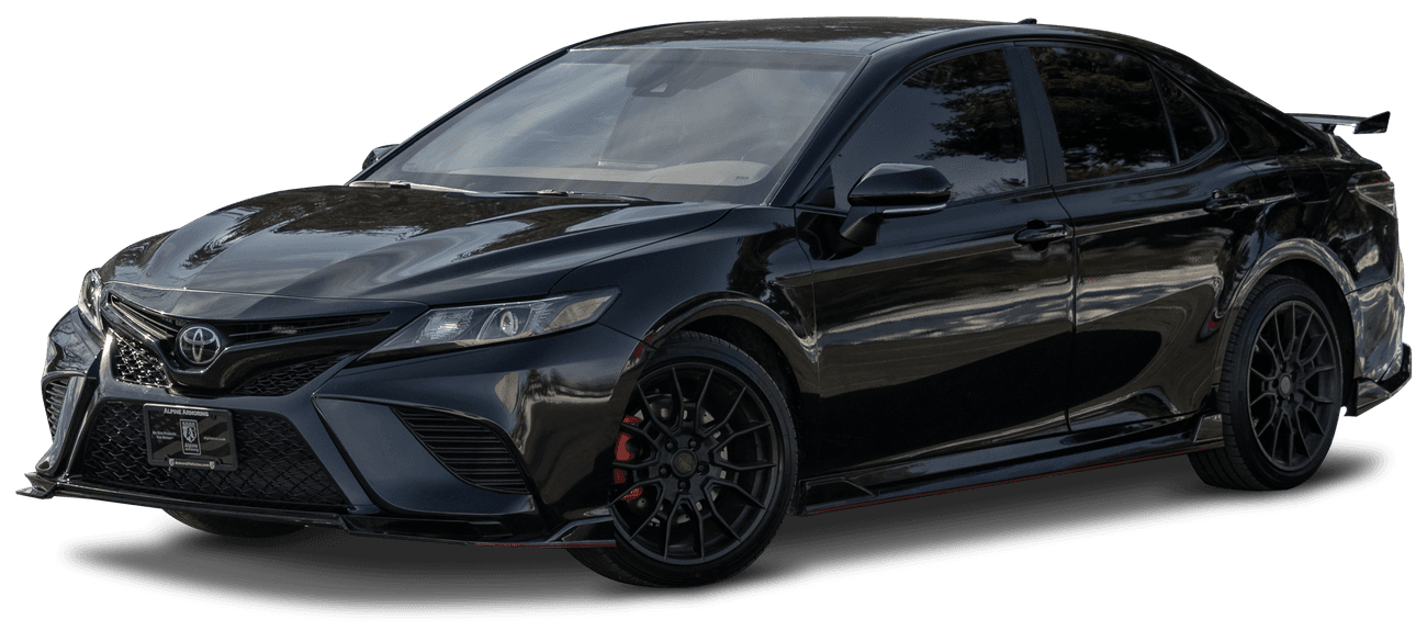 A black armored Toyota Camry TRD sedan with darkly tinted windows, red brake calipers, and sports wheels, viewed from the front-left angle.