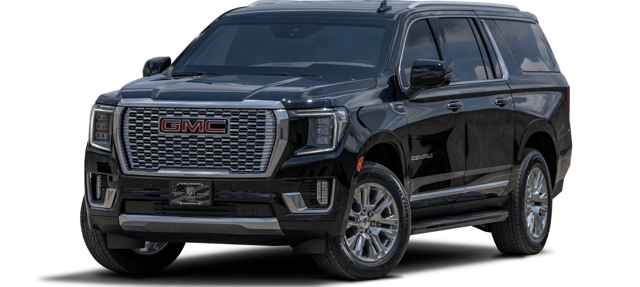 A sleek black GMC Denali SUV is parked, showcasing its front and side profile. The vehicle features a prominent grille, silver accents, and large alloy wheels.