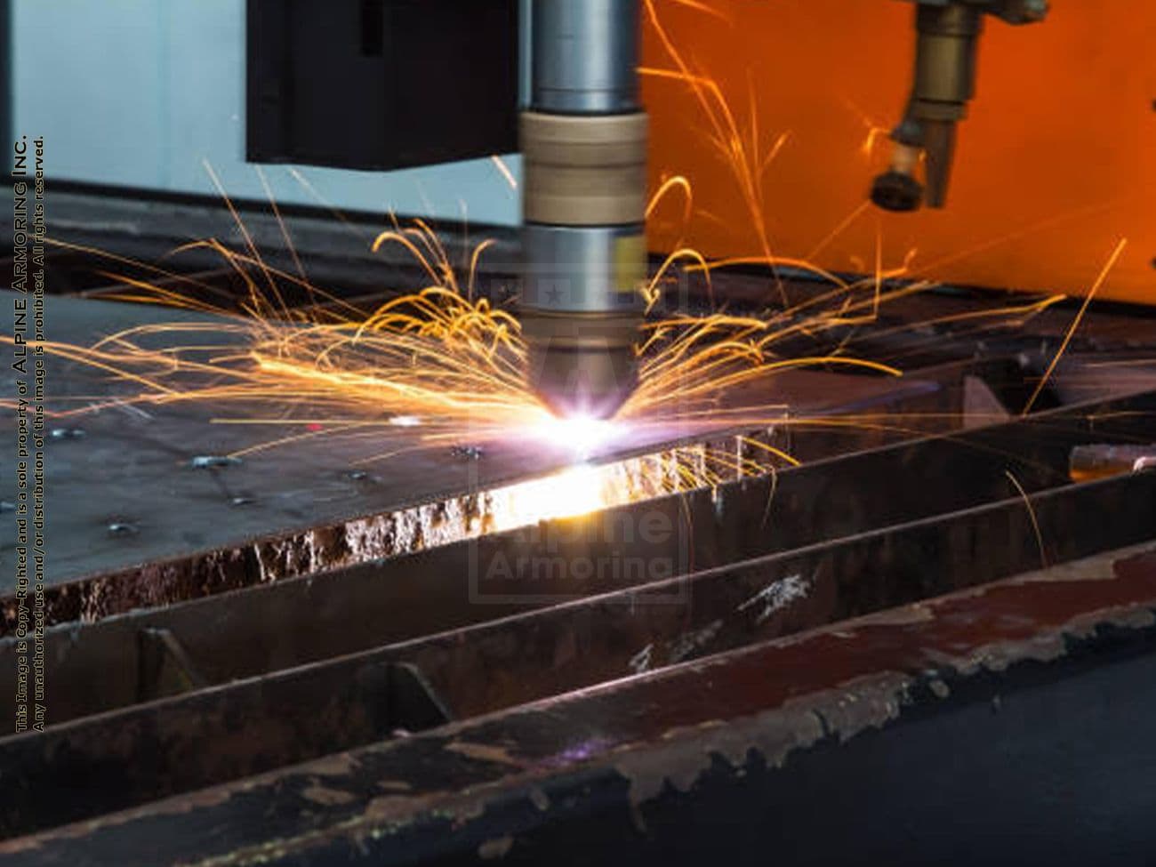 A CNC plasma cutting machine cutting through a sheet of metal with sparks flying around.