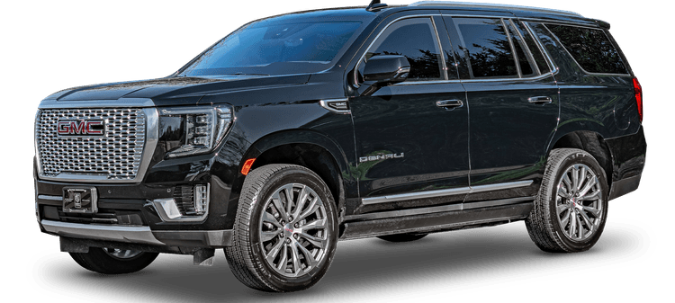 An armored black GMC Yukon Denali SUV, shown from a front-side angle, displaying its prominent grille, sleek design, and alloy wheels.