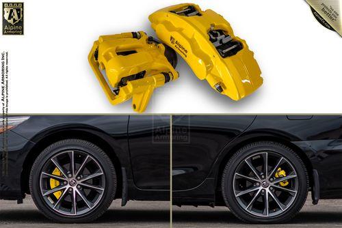 Yellow brake calipers from Alpine Armoring are shown separately and installed on a black car with multi-spoke wheels.