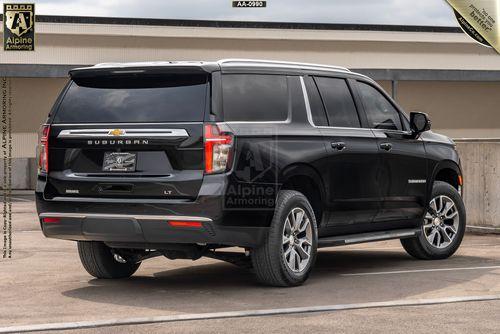 Black Chevrolet Suburban LT parked in an outdoor setting, showcasing rear and driver-side views.