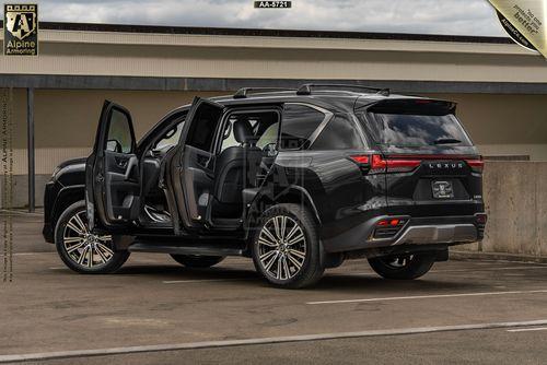 A Lexus LX600 from Alpine Armoring with multiple doors open, showcasing its reinforced design. The vehicle is black with a tactical build, designed for high-security purposes.