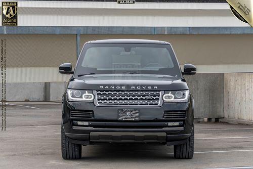 Front view of a black Range Rover Autobiography parked in a parking garage with a custom license plate.