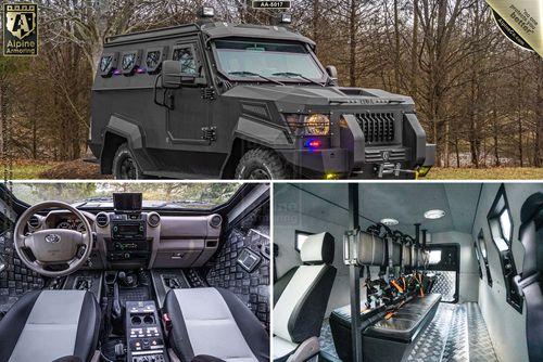 A matte black armored SWAT APC CUDA shown from the exterior, interior front dashboard, and rear compartment with gun racks. The background features a wooded area.