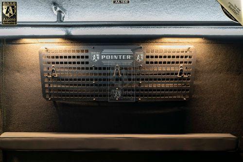 A SWAT Van - Pointer's overhead compartment illuminated by two small lights; the focus is on a black, perforated metal panel labeled "Pointer" with various symbols.