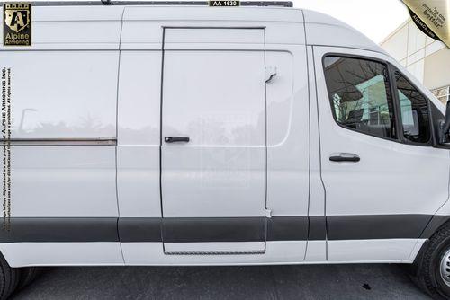 Side view of a white cargo Pointer van . The van has a side sliding door and tinted windows.