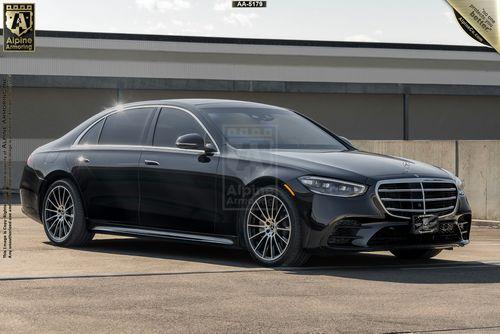 A black Mercedes-Benz S-Class (S580 4MATIC) from Alpine Armoring  parked in an outdoor setting, highlighting its elegant design, smooth lines, and stylish alloy wheels. The luxury sedan exudes sophistication and modernity.